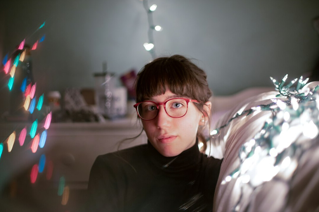 Portrait of a woman television director with short hair and glasses